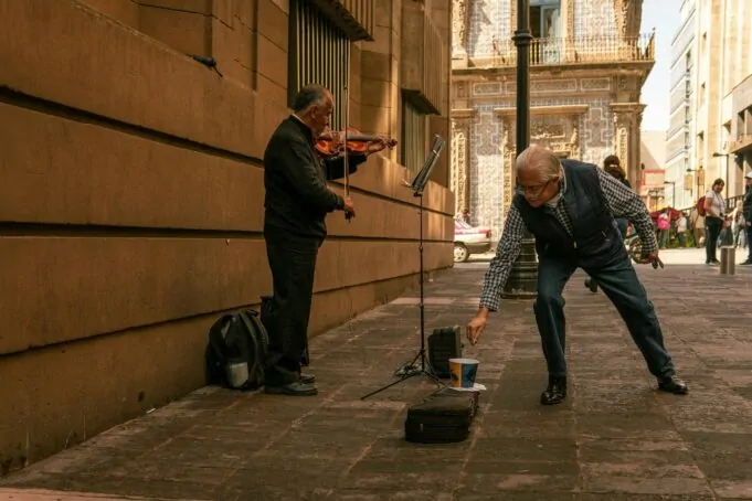 man playing violin on a street