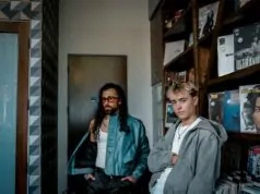 trendy young men in urban record store setting