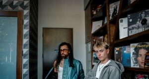 trendy young men in urban record store setting