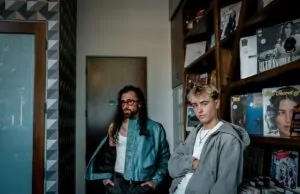 trendy young men in urban record store setting
