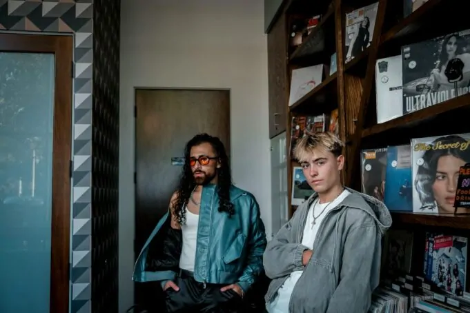 trendy young men in urban record store setting